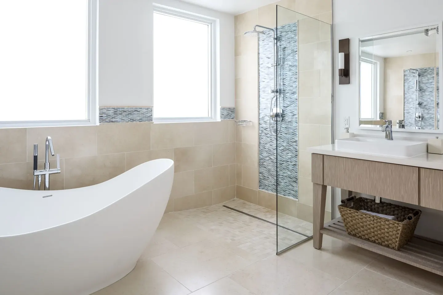 Light-filled bathroom with sculptural tub and glass shower at Windjammer Landing Resort and Residences.