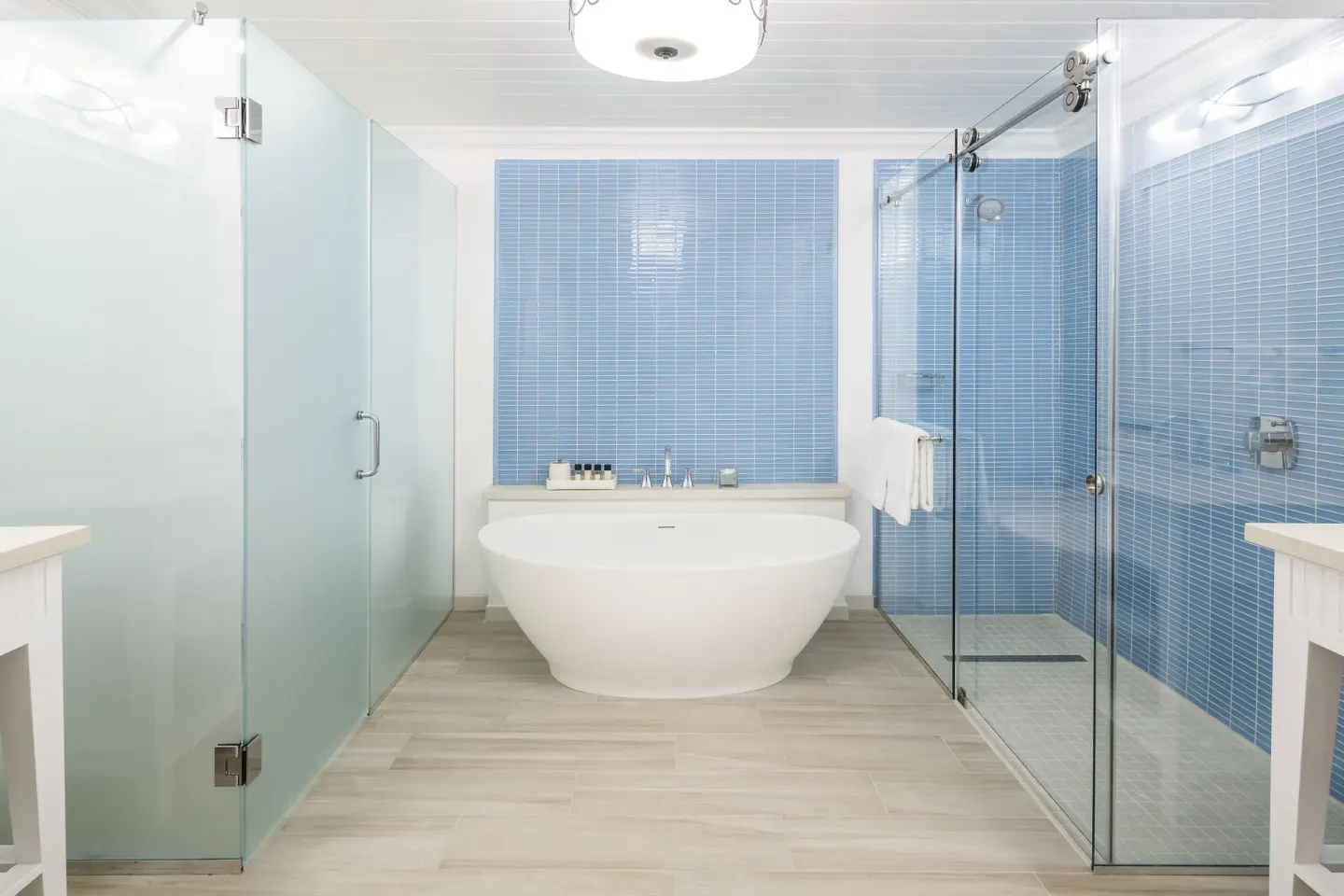 Modern bathroom with freestanding tub and glass shower at Windjammer Landing Resort and Residences.
