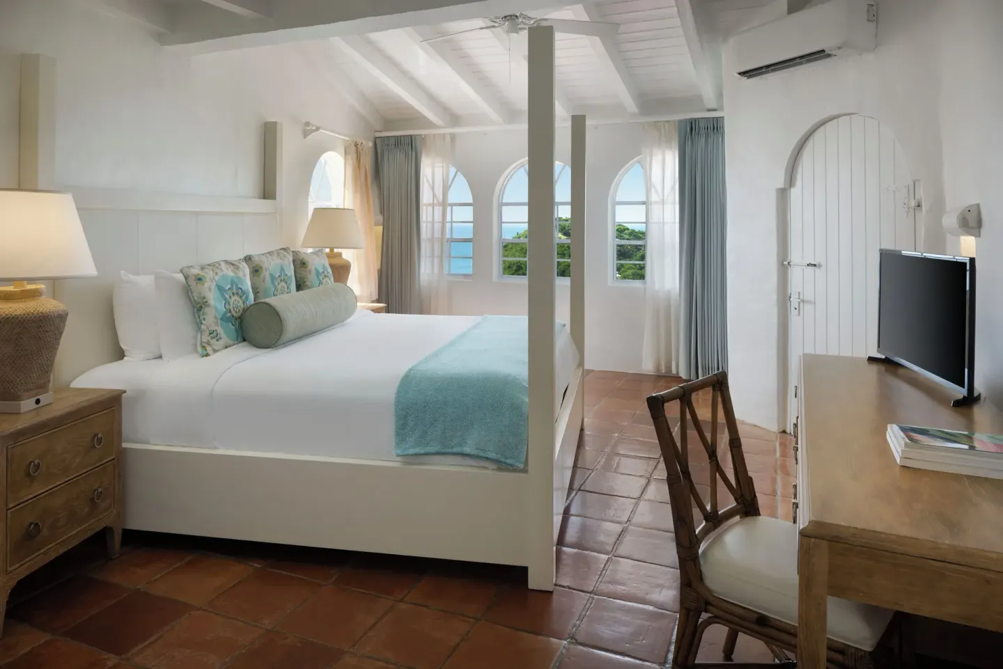 Hilltop one-bedroom villa bedroom with four-poster bed at Windjammer Landing Resort and Residences.