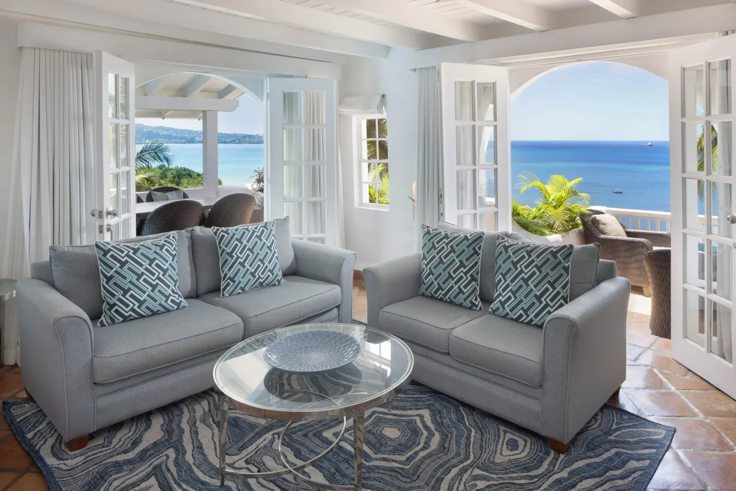 Hilltop two-bedroom villa living room with ocean-view terraces at Windjammer Landing Resort and Residences.