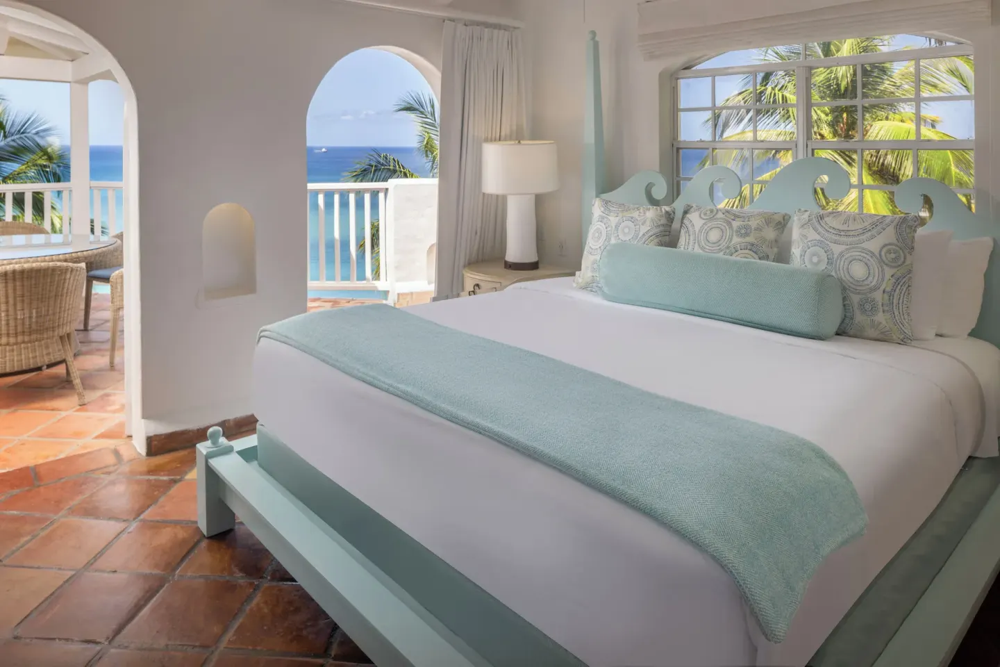 Hilltop two-bedroom villa king bedroom with balcony ocean view at Windjammer Landing Resort and Residences.