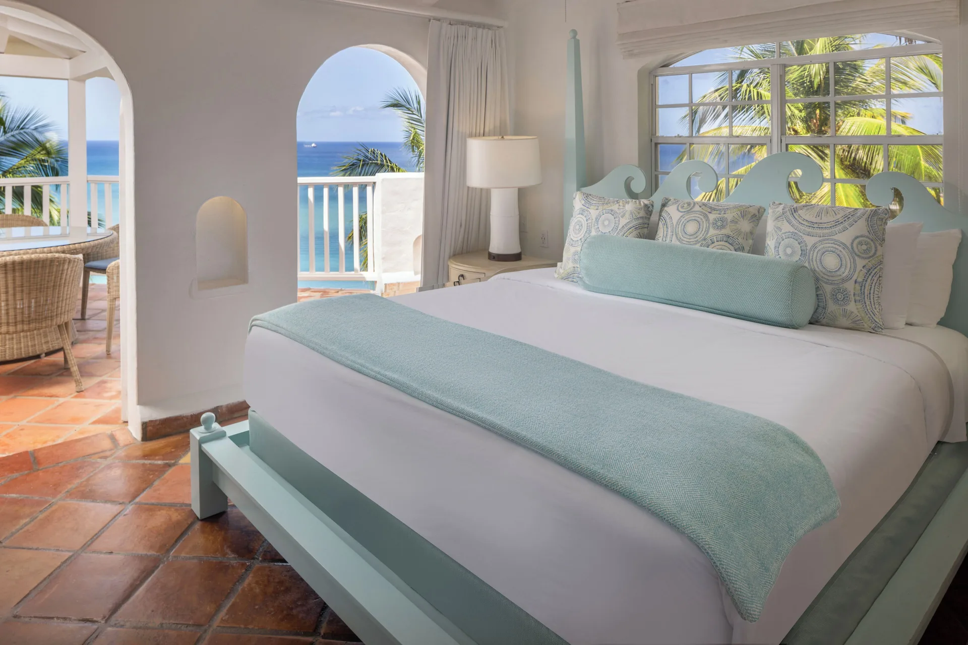 Hilltop two-bedroom villa king bedroom with balcony ocean view at Windjammer Landing Resort and Residences.