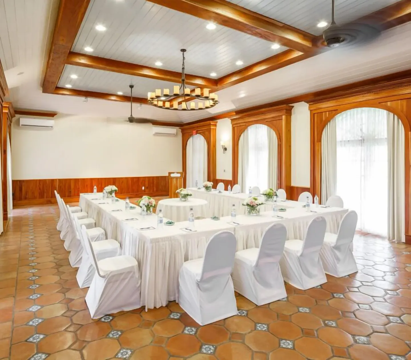 Meeting room with U-shaped white table setup at Windjammer Landing Resort and Residences.