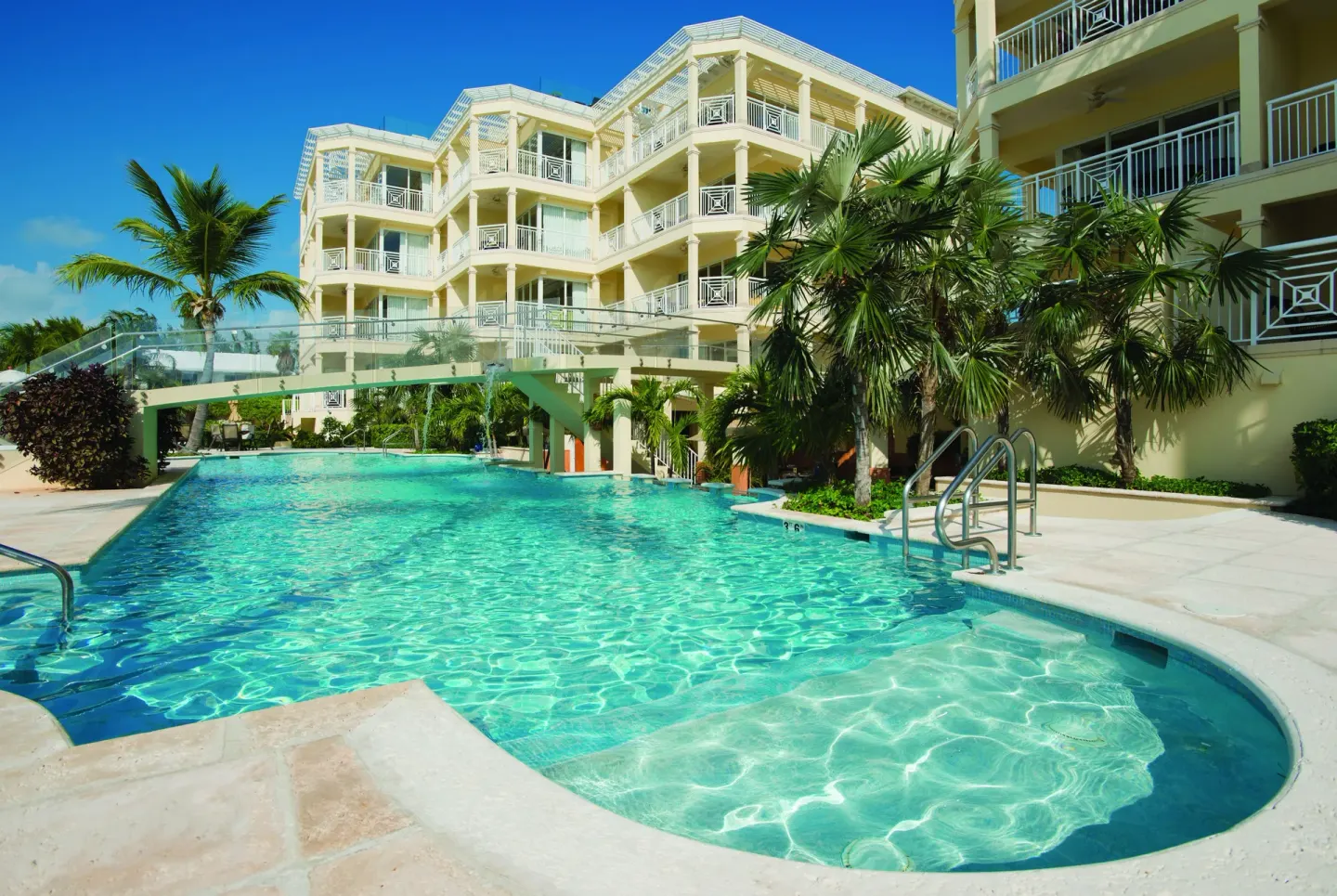 Large outdoor pool beside resort balconies at Windsong on the Reef.
