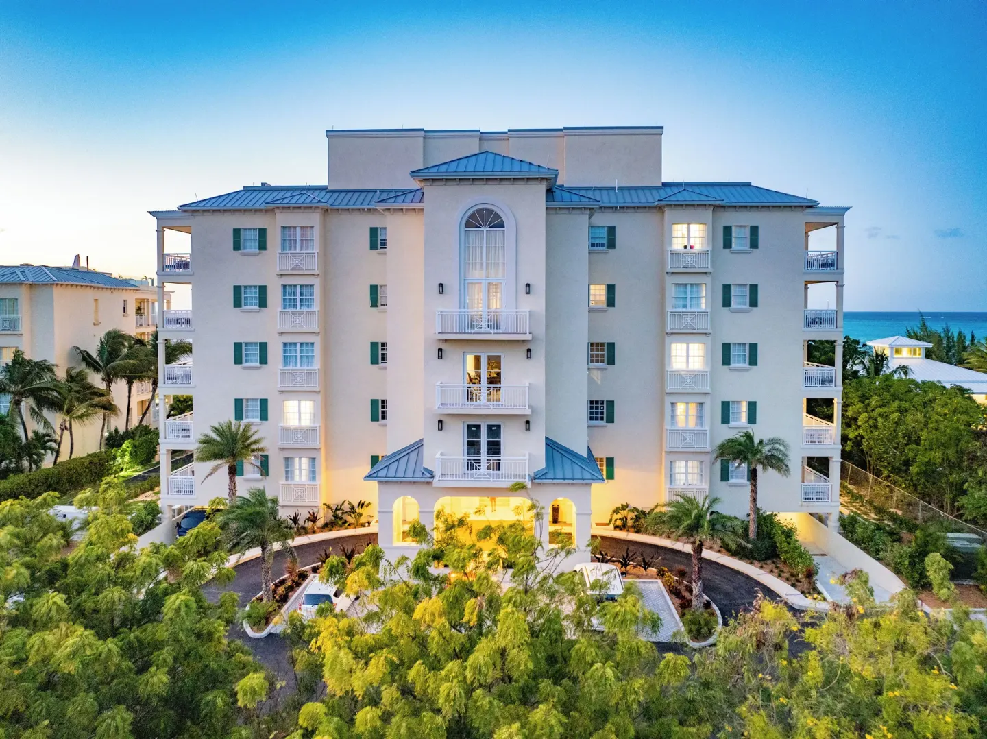 Resort building with balconies and gardens at dusk at Windsong on the Reef.