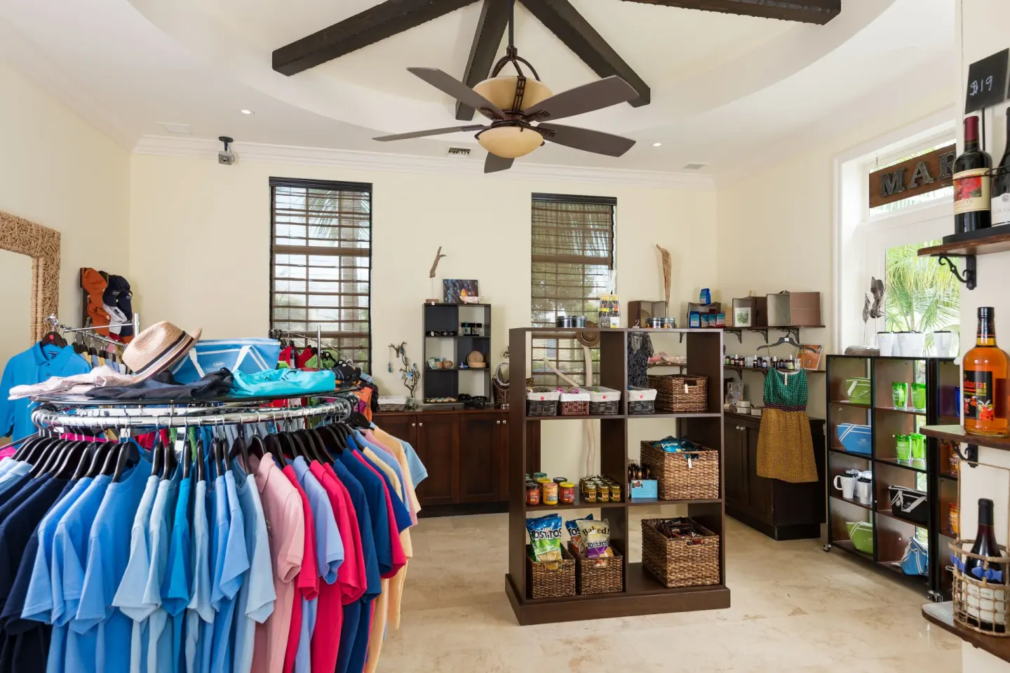 A resort shop displays shirts, snacks, bottles, and beach items at Windsong on the Reef.