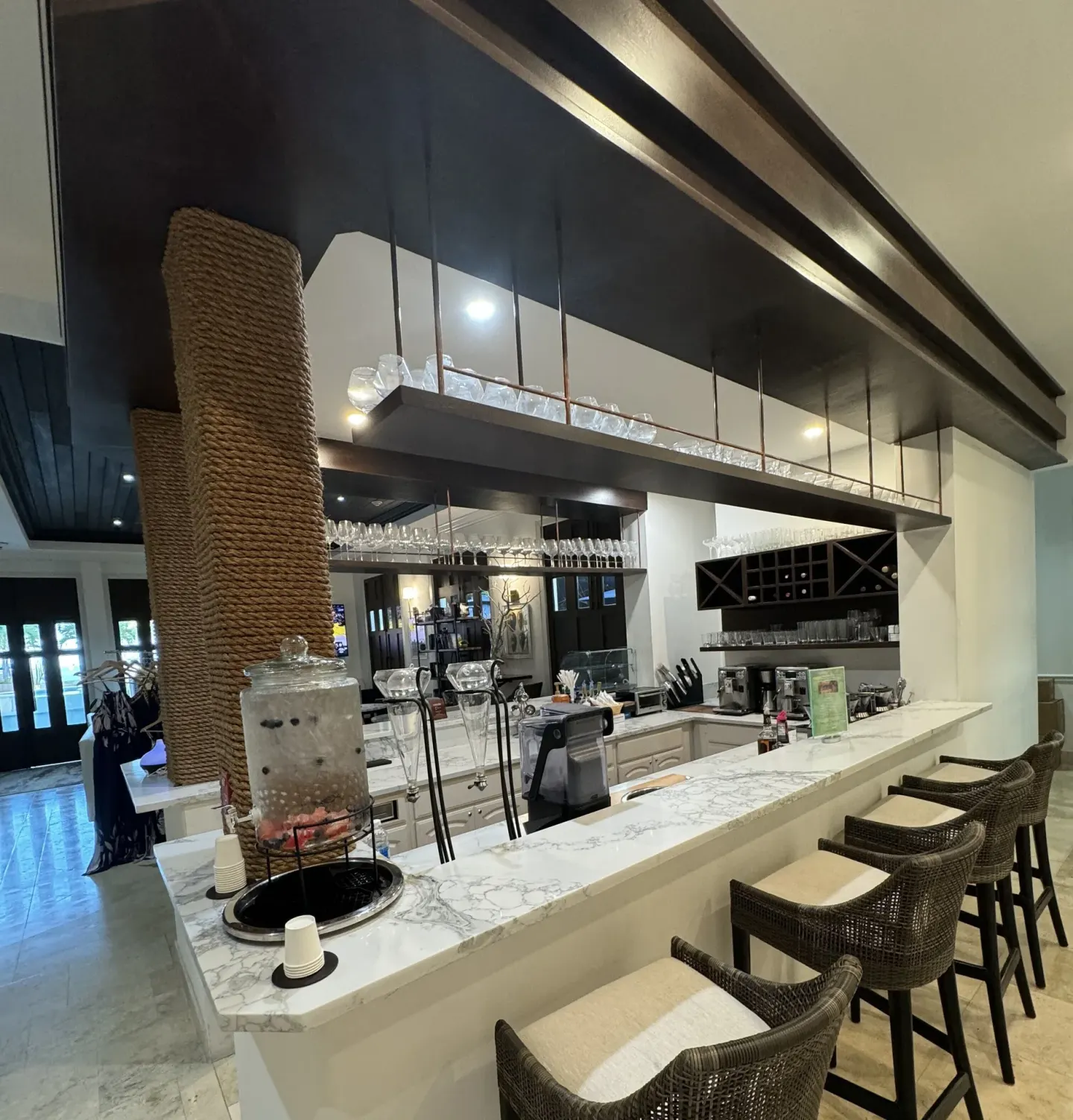 Marble coffee bar counter with stools and glassware at Windsong on the Reef.