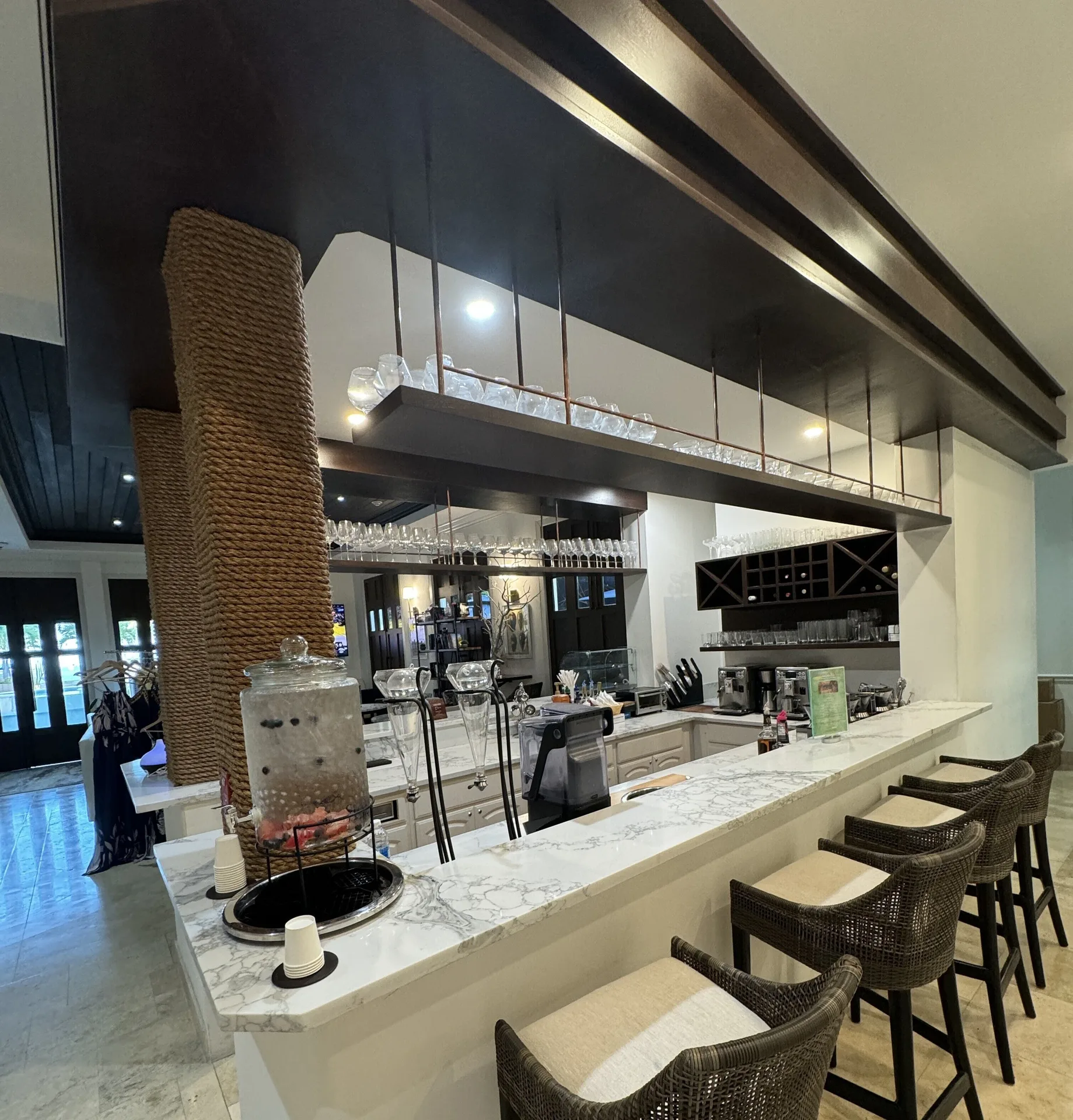 Marble coffee bar counter with stools and glassware at Windsong on the Reef.