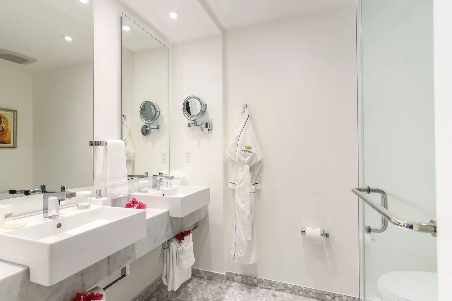 Bathroom with double sinks and glass shower in a Bungalow 1 Bedroom at Windsong on the Reef.