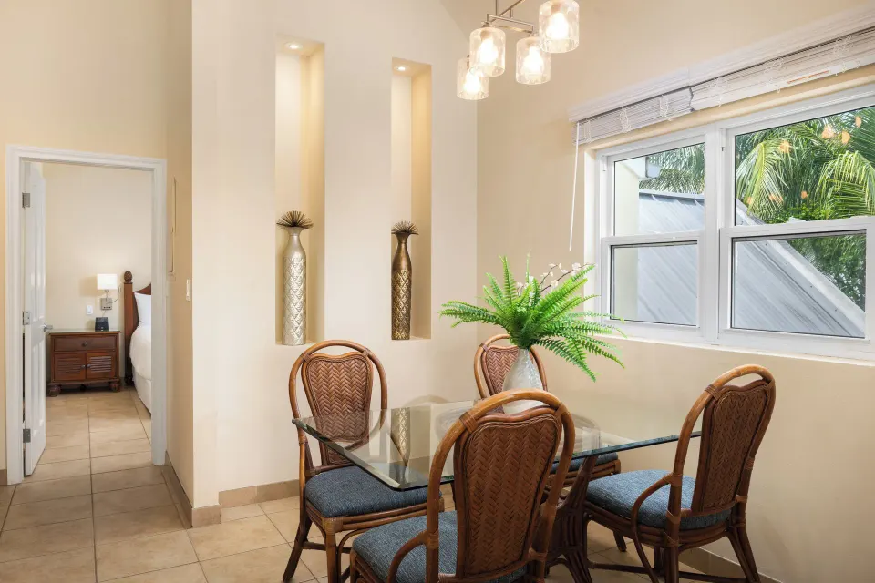 Dining table near windows in a Bungalow 1 Bedroom at Windsong on the Reef.
