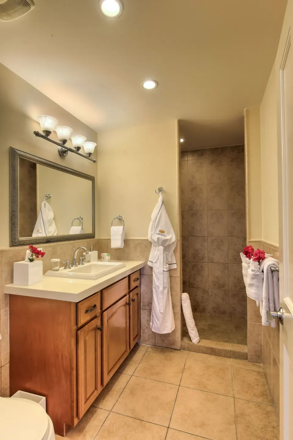 Two-bedroom bungalow bathroom with vanity and tiled shower at Windsong on the Reef.