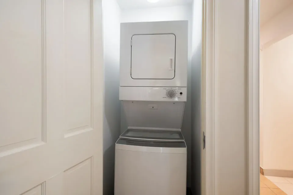 Bungalow three-bedroom laundry closet with stacked washer and dryer at Windsong on the Reef.