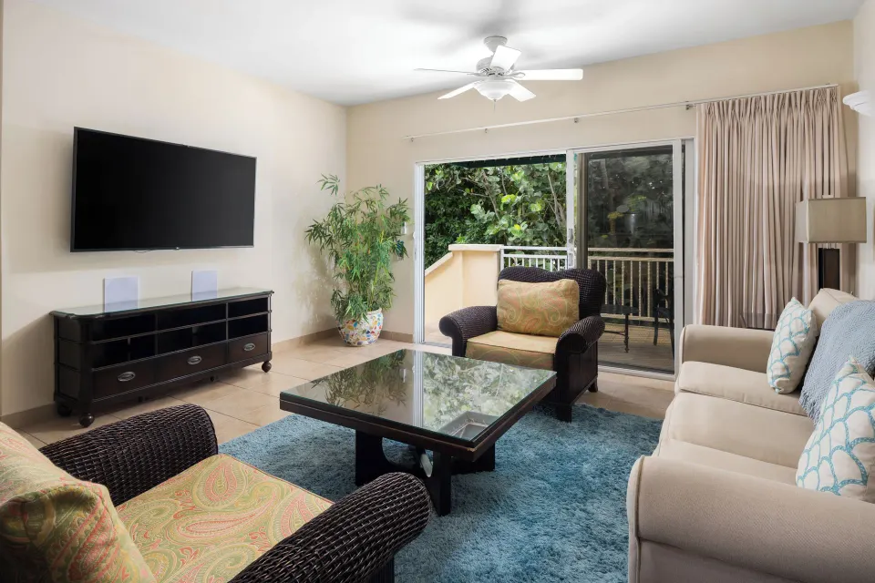 Bungalow three-bedroom living room with balcony doors at Windsong on the Reef.