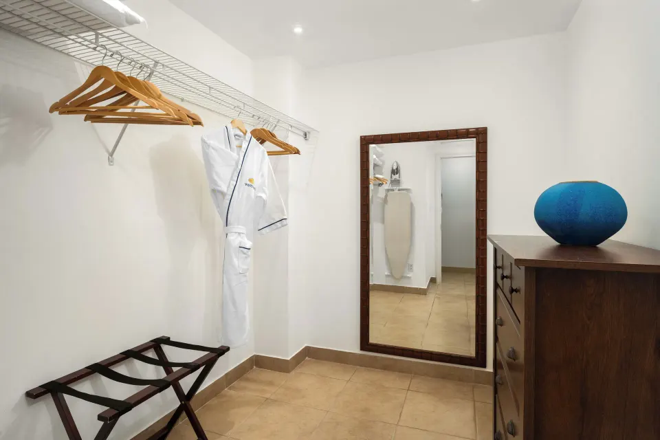 Bungalow three-bedroom closet with robe and mirror at Windsong on the Reef.