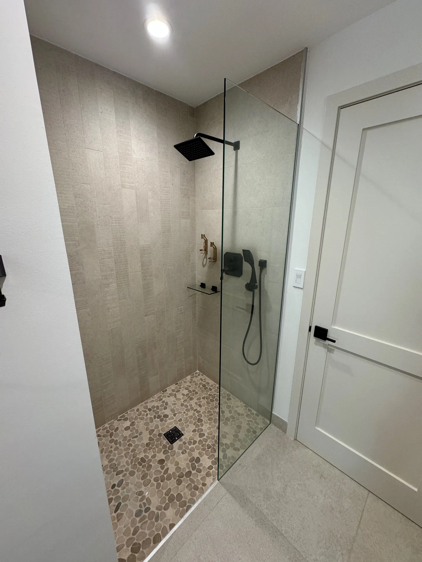 Junior Suite walk-in shower with glass partition at Windsong on the Reef.