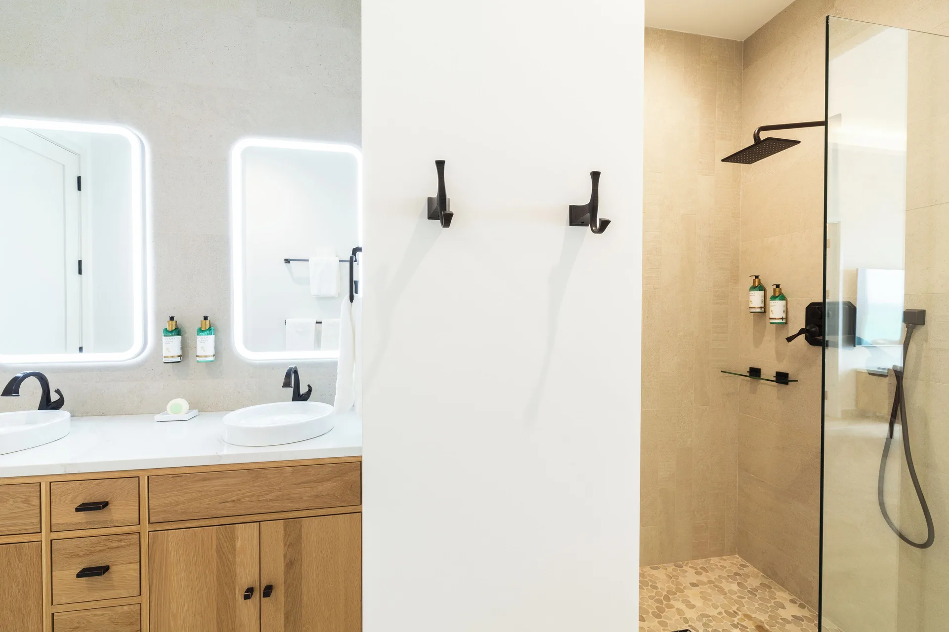 Junior Suite beachfront bathroom with double vanity and glass shower at Windsong on the Reef.