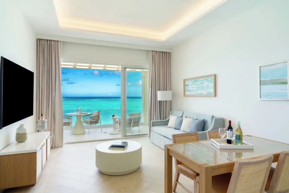 Junior Suite living room with oceanfront balcony at Windsong on the Reef.