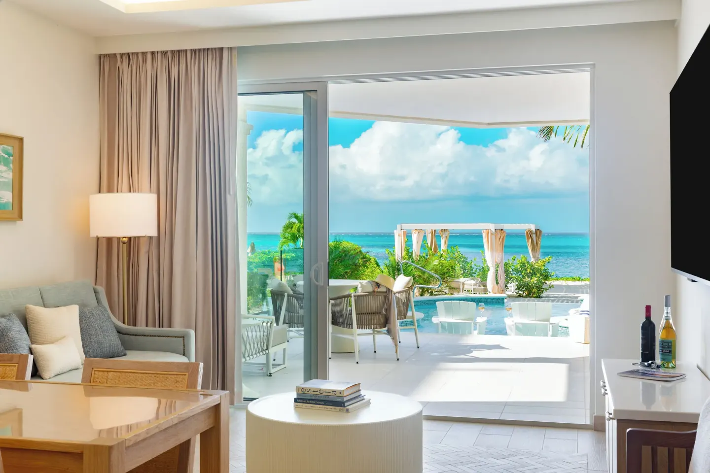 Beachfront pool access junior suite living area at Windsong on the Reef with patio and ocean view.