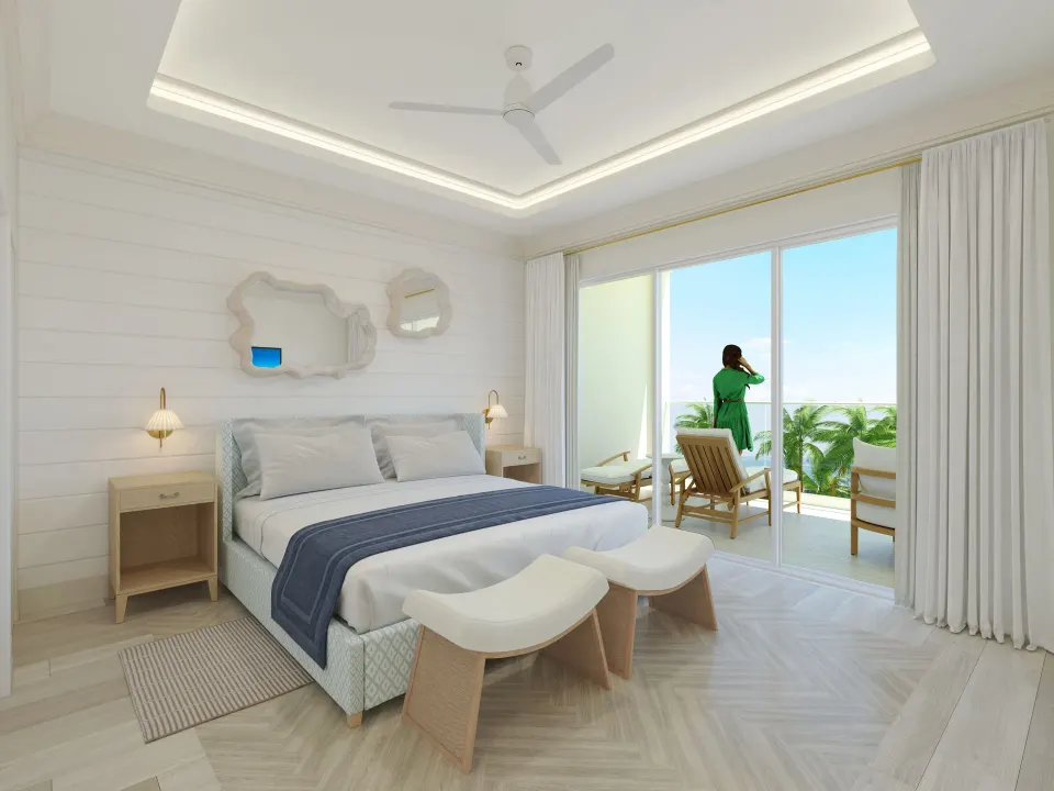 King bed and balcony seating in a beachfront Junior Suite at Windsong on the Reef.