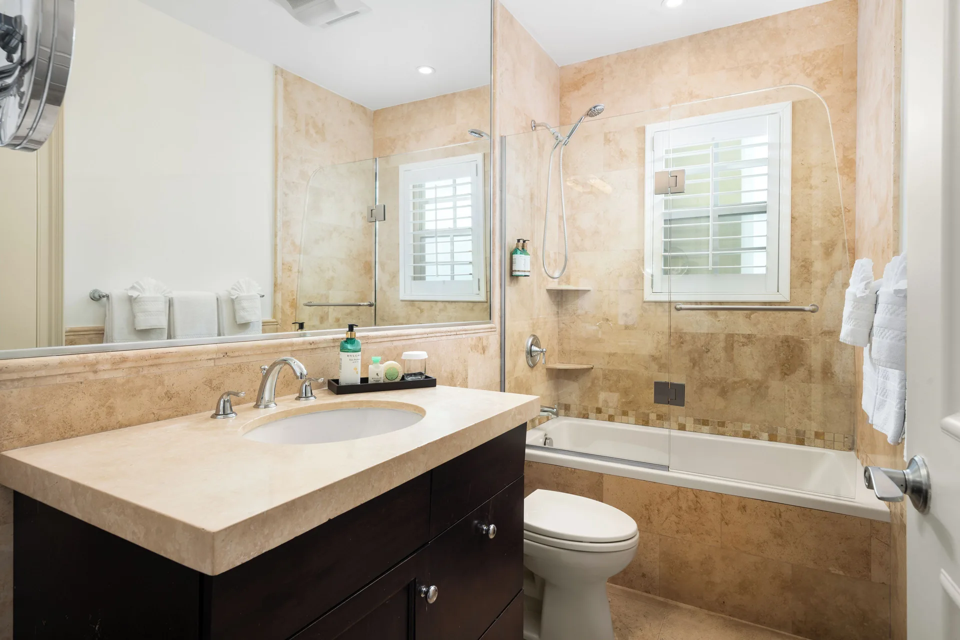 Studio bathroom with vanity and tub shower at Windsong on the Reef.