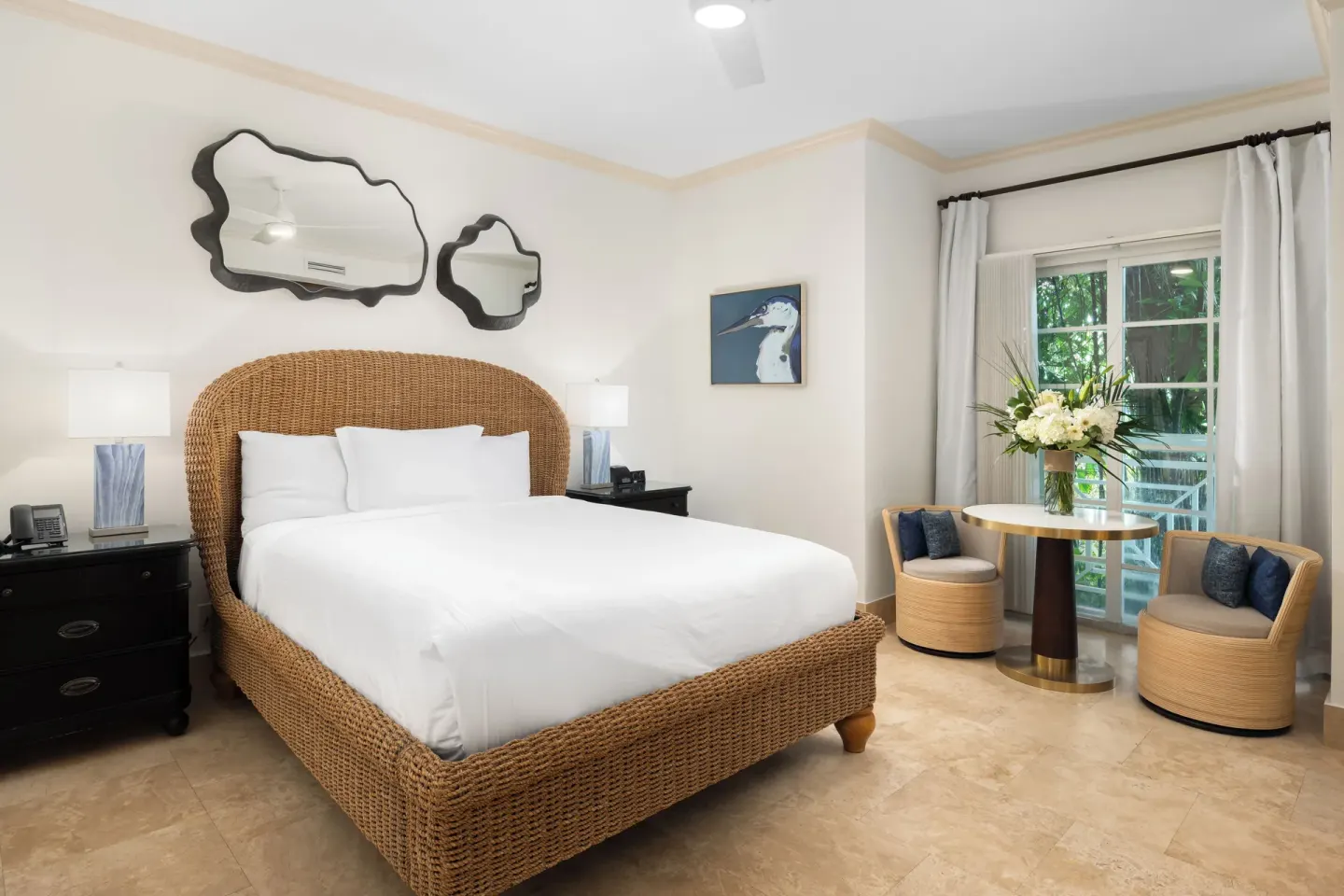 Studio king bedroom with wicker bed and sitting area at Windsong on the Reef.