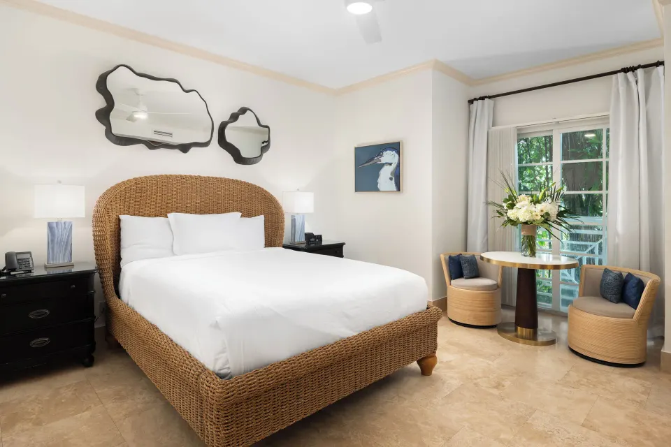 Studio king bedroom with wicker bed and sitting area at Windsong on the Reef.