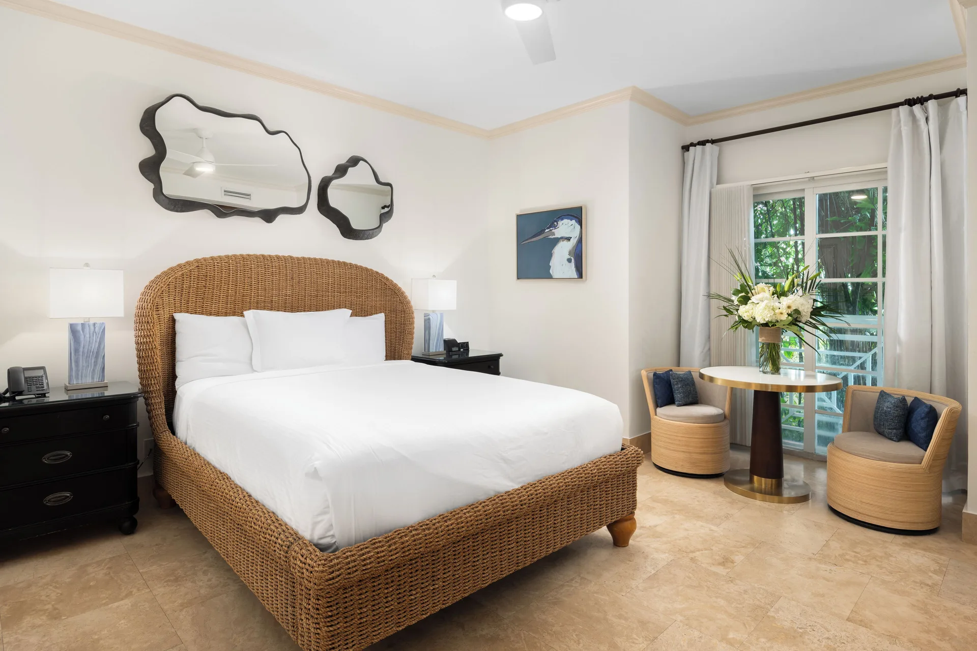 Studio king bedroom with wicker bed and sitting area at Windsong on the Reef.