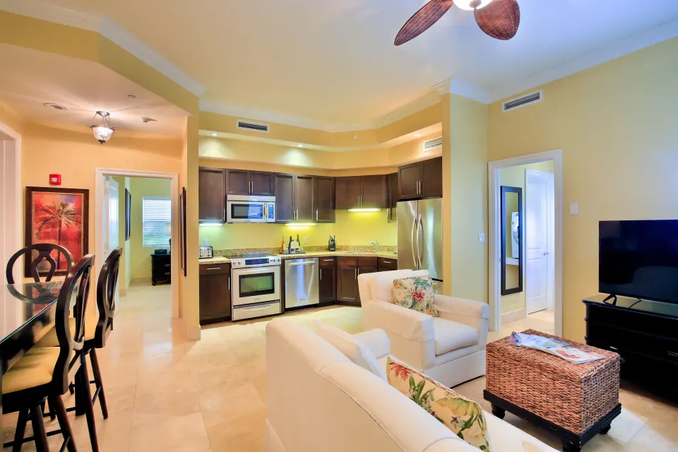 One Bedroom Suite living area, dining table, and open kitchen at Windsong on the Reef.