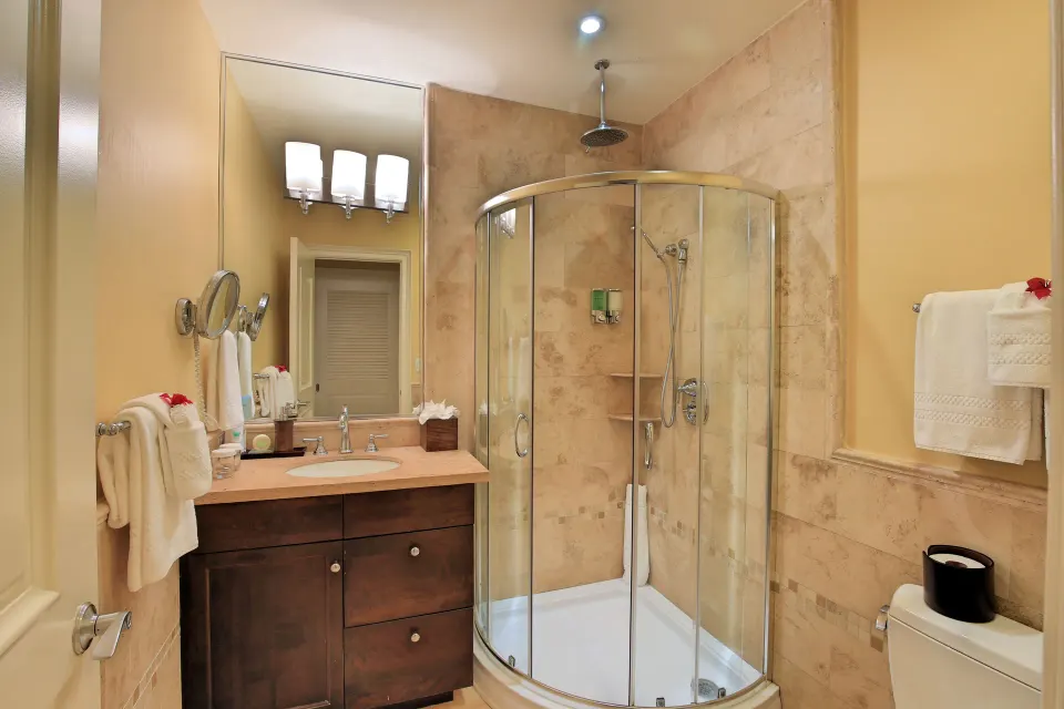 Suite bathroom with glass corner shower and vanity at Windsong on the Reef.