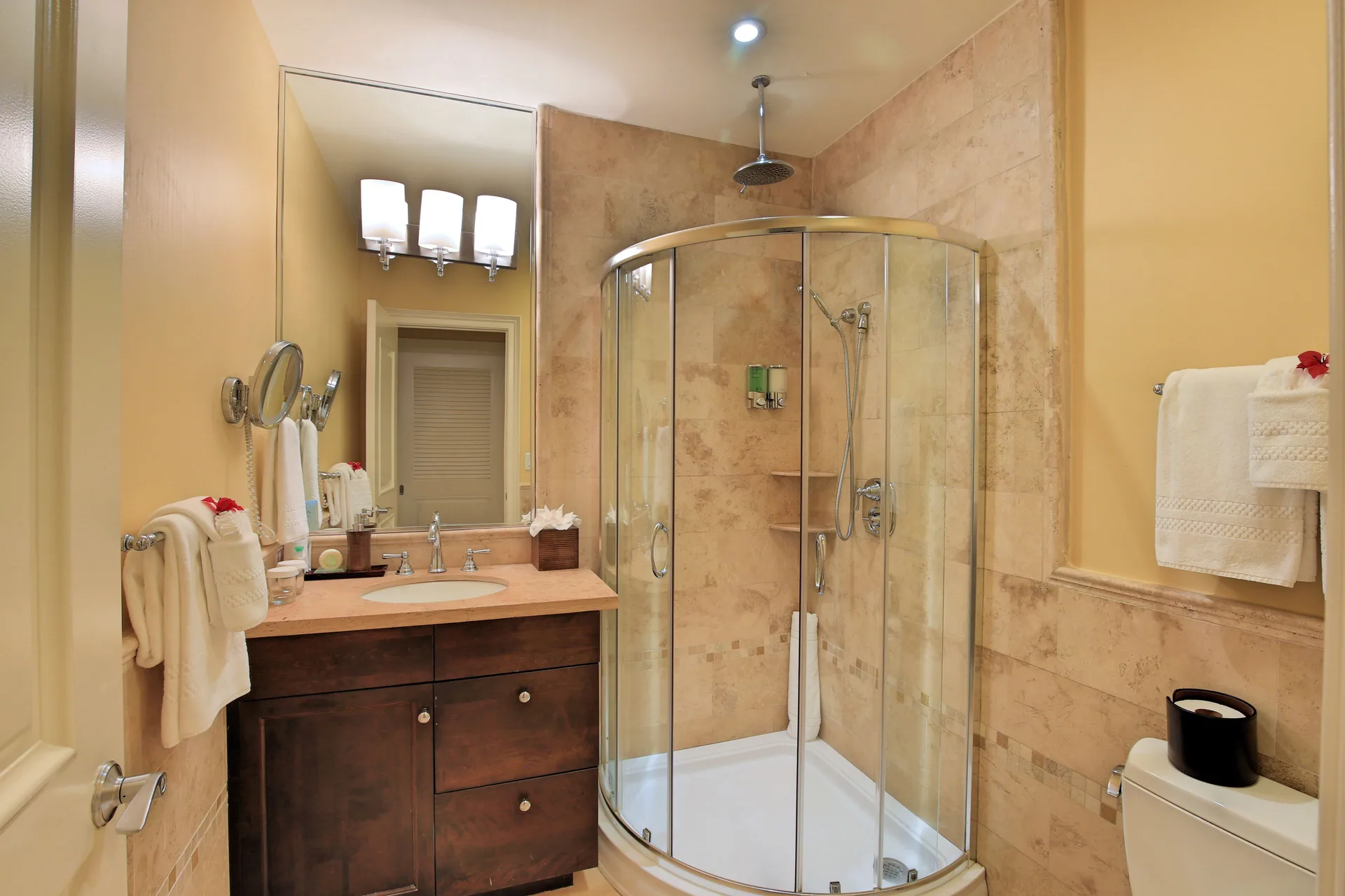 Suite bathroom with glass corner shower and vanity at Windsong on the Reef.
