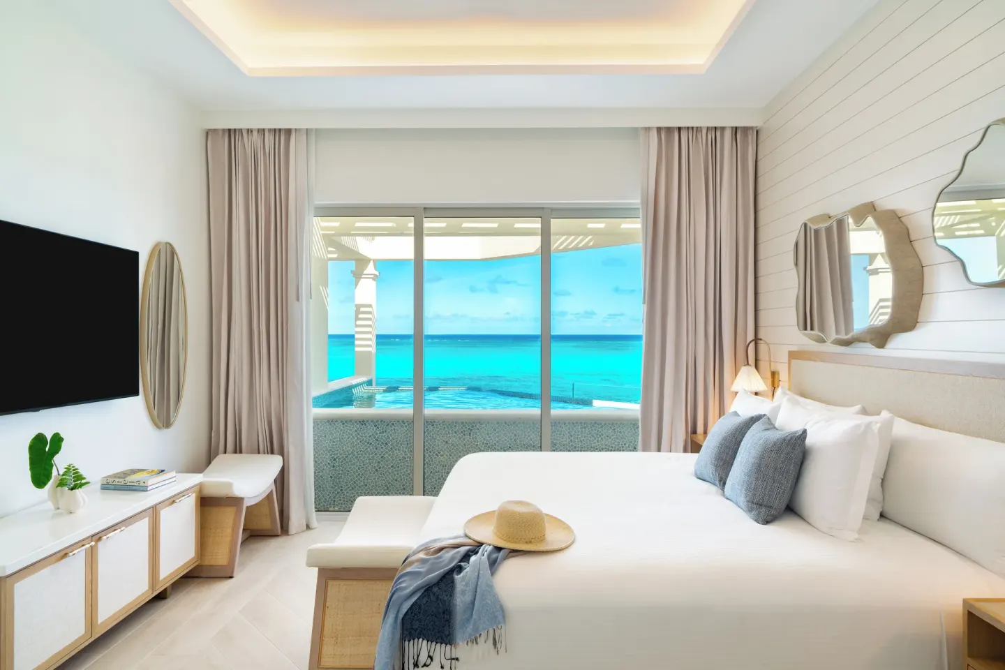 Beachfront villa bedroom with king bed and ocean view at Windsong on the Reef.