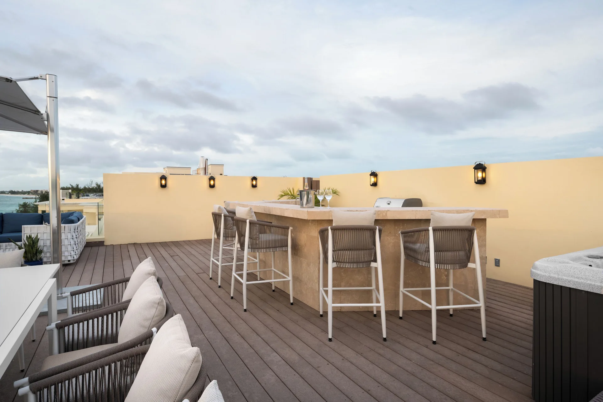 Oceanfront villa terrace bar seating and hot tub at Windsong on the Reef.