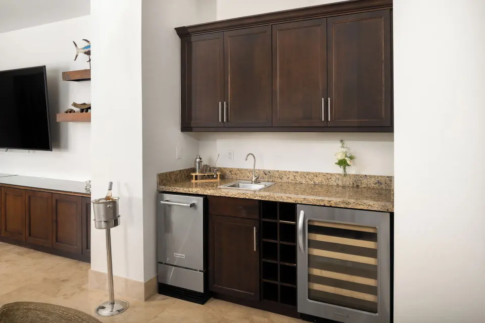 Oceanfront villa wet bar with sink and wine cooler at Windsong on the Reef.