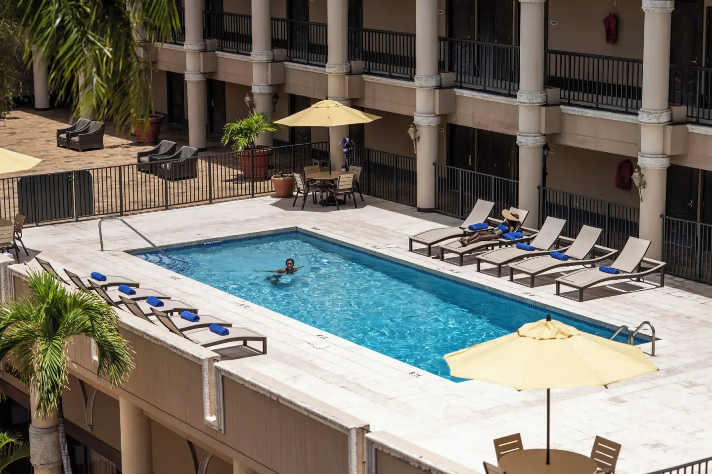 Elevated view of the courtyard pool and lounge chairs at Windward Passage Hotel.