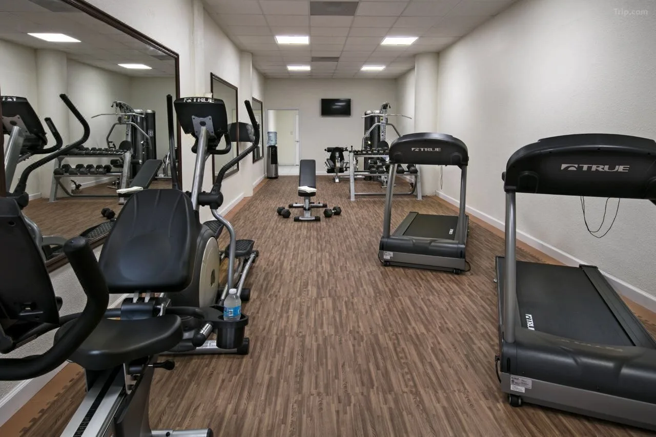 Fitness room with treadmills, elliptical, and weights at Windward Passage Hotel.