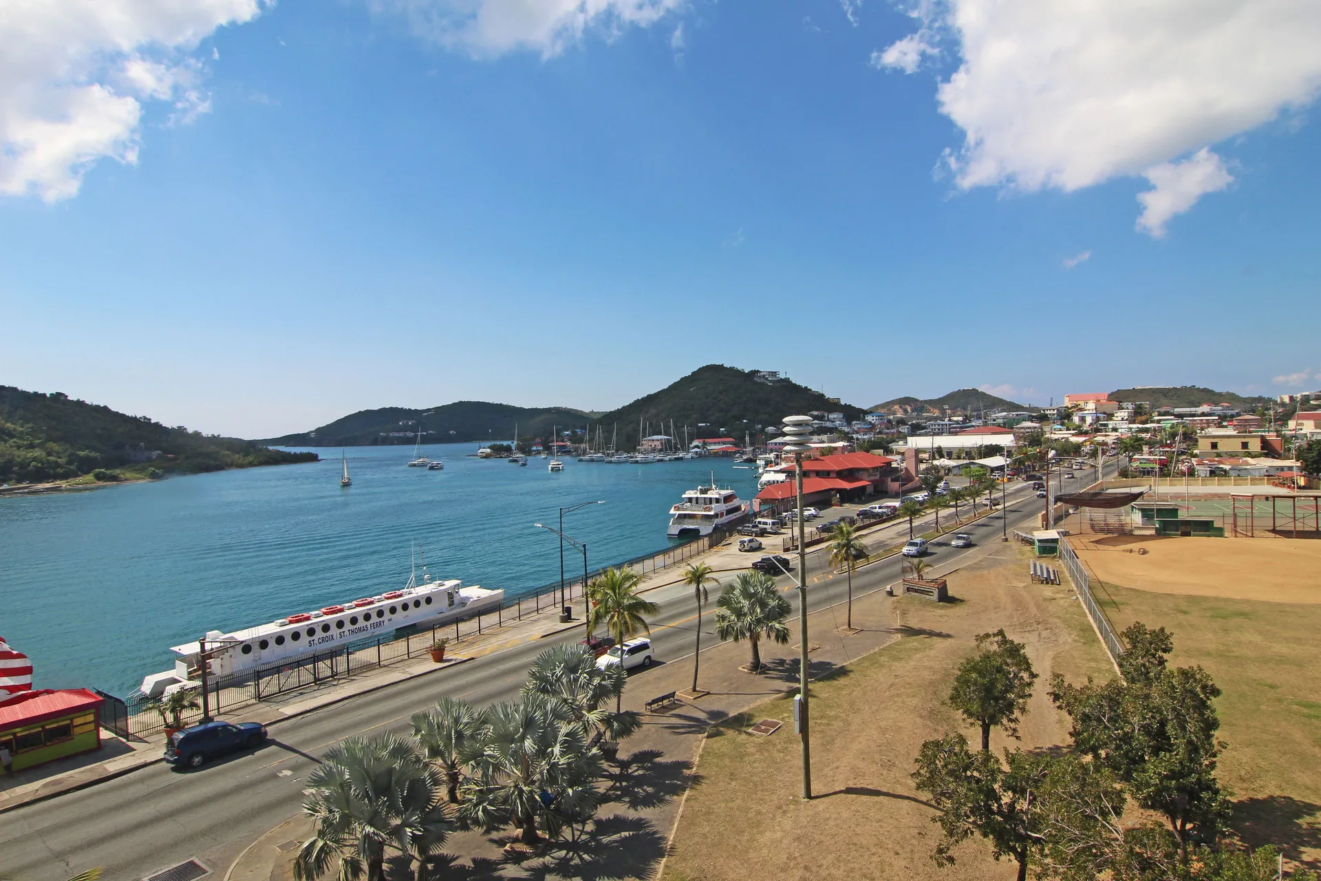 Waterfront road, marina, and hillside harbor view near Windward Passage Hotel.