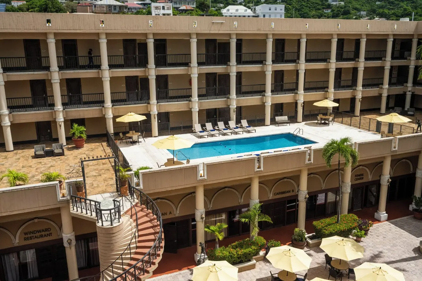 Elevated view of the pool deck and courtyard restaurant fronts at Windward Passage Hotel.