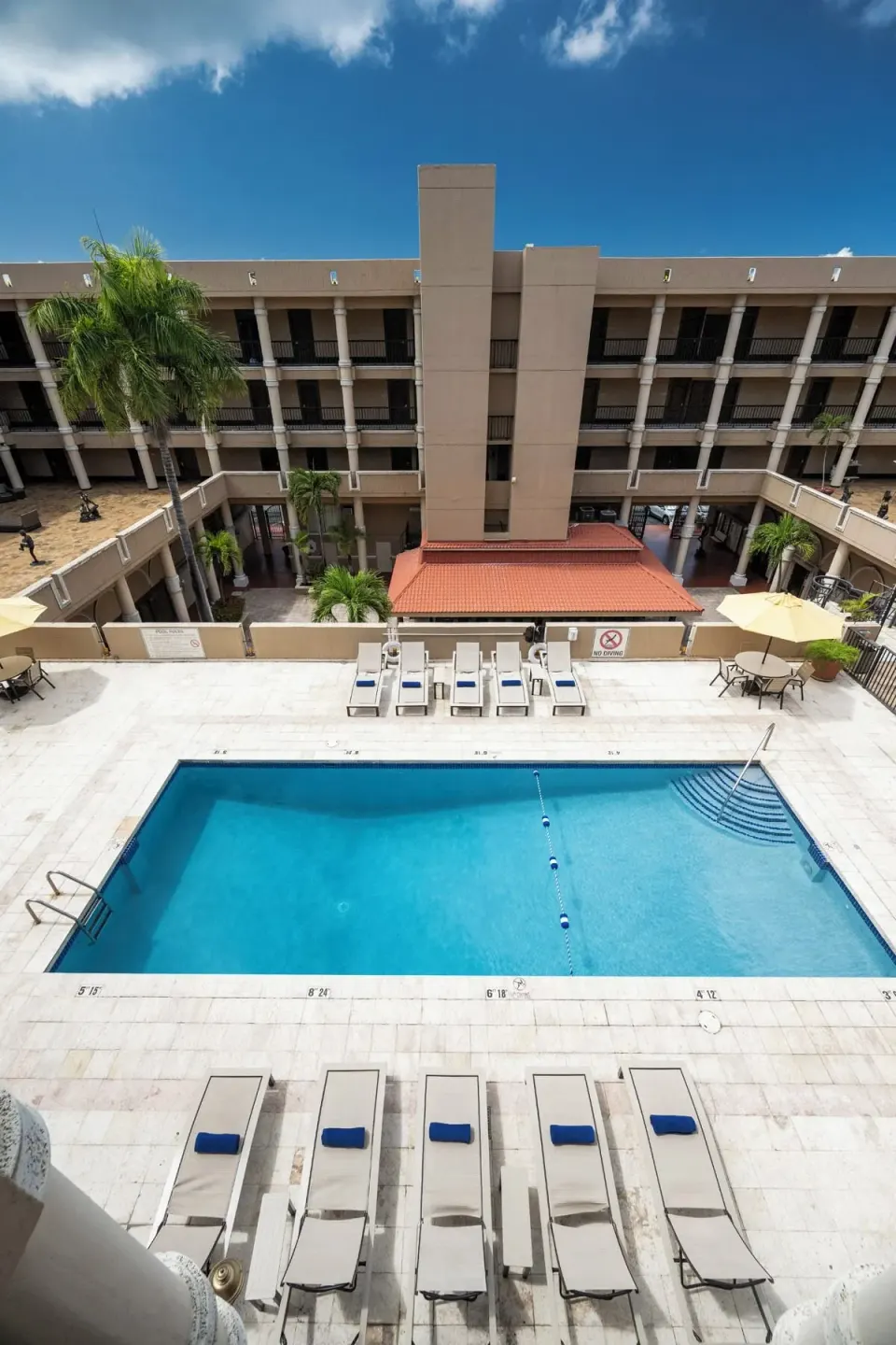 Pool, loungers, and multi-level courtyard at Windward Passage Hotel.