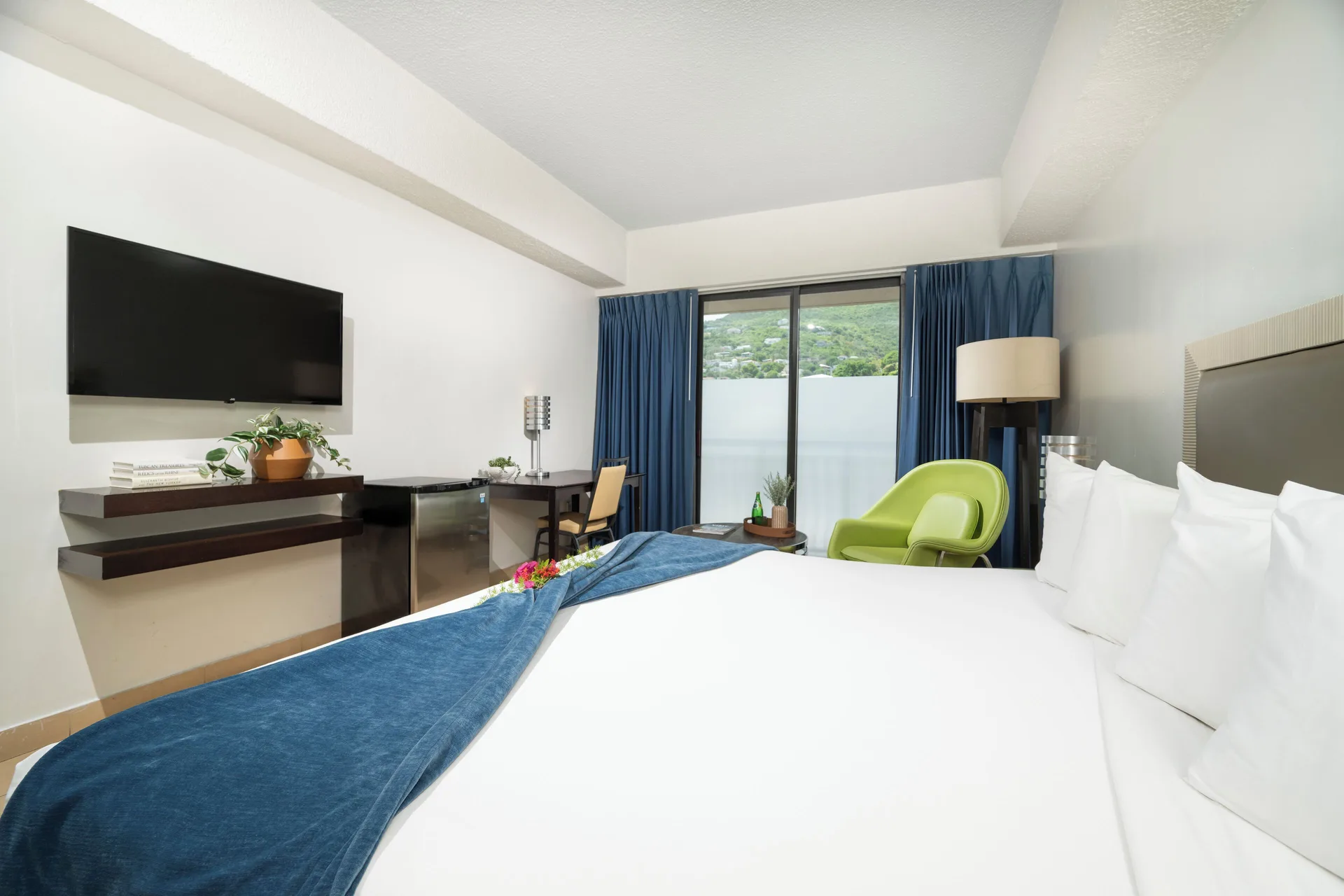Standard Room at Windward Passage Hotel with king bed, TV, mini fridge, and hillside view in Key West.