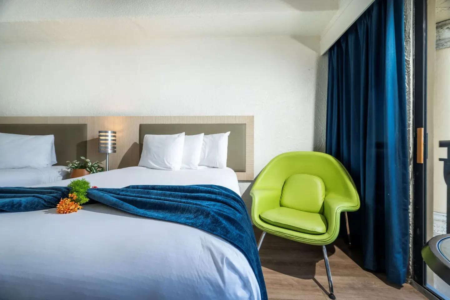 Superior Room Ocean View bed and green chair at Windward Passage Hotel.
