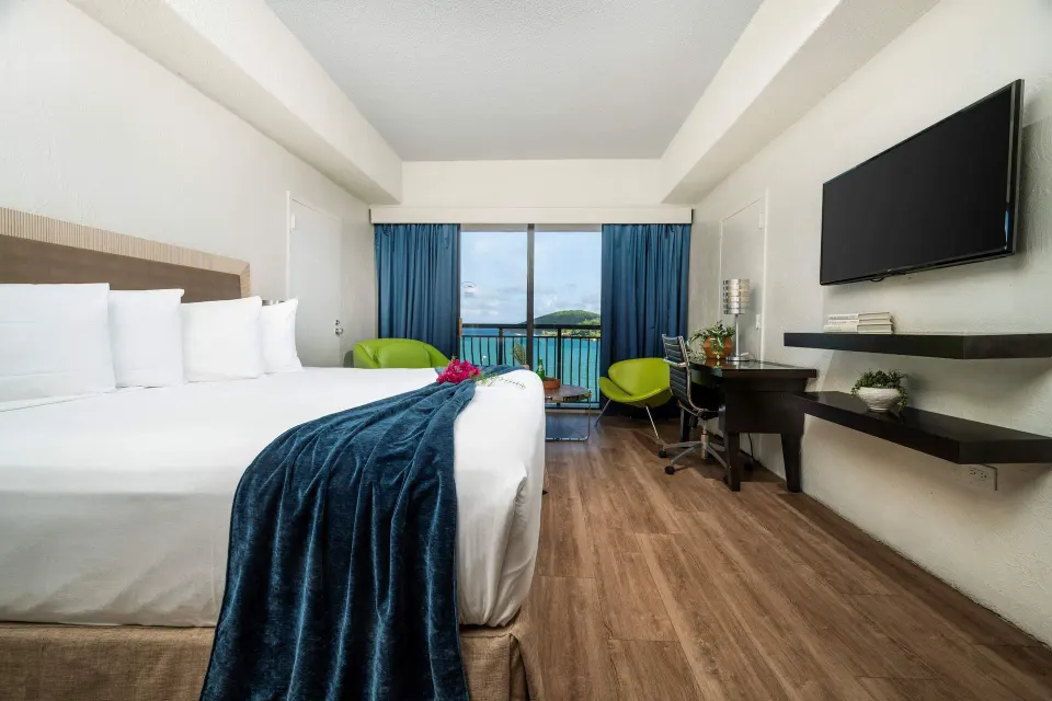 Superior Ocean View room with king bed, desk, and balcony view at Windward Passage Hotel.
