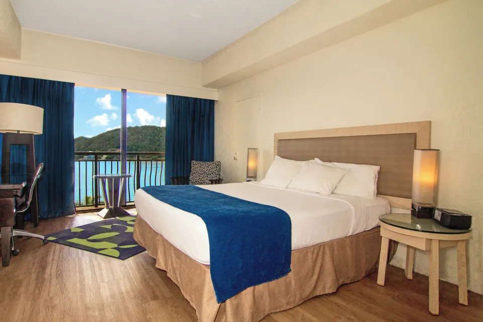 Superior Room Ocean View king bed and balcony at Windward Passage Hotel.