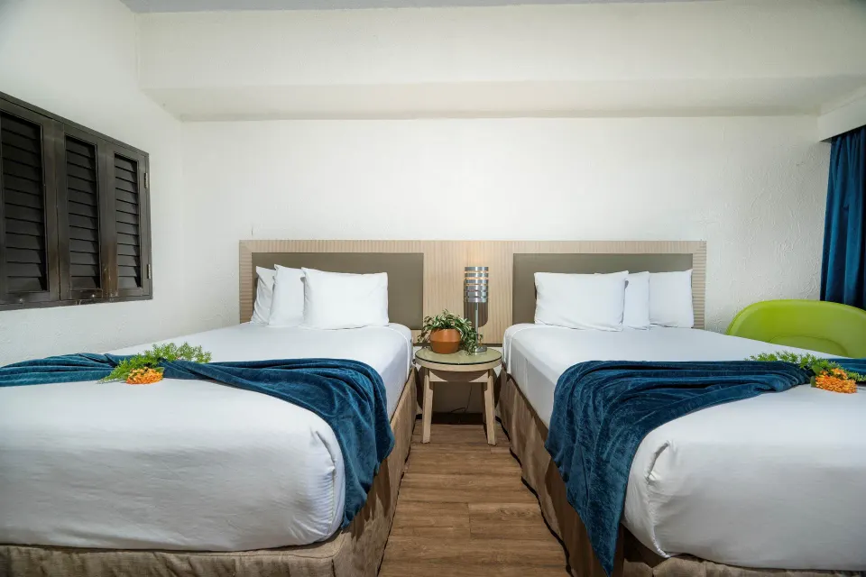 Superior Room Ocean View two beds with blue throws at Windward Passage Hotel.