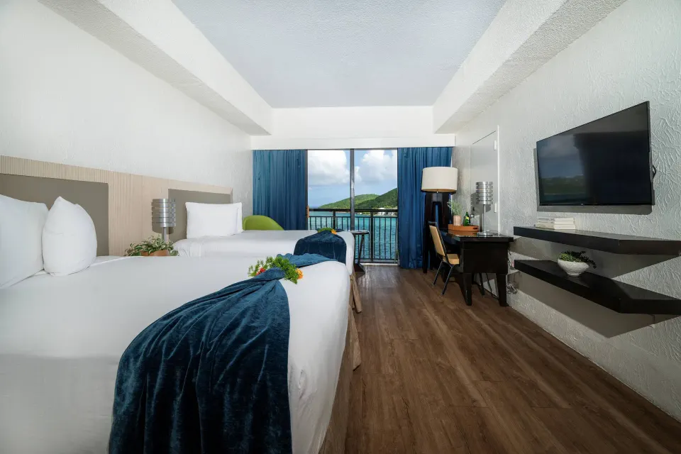 Superior Room Ocean View two beds, TV, and desk at Windward Passage Hotel.
