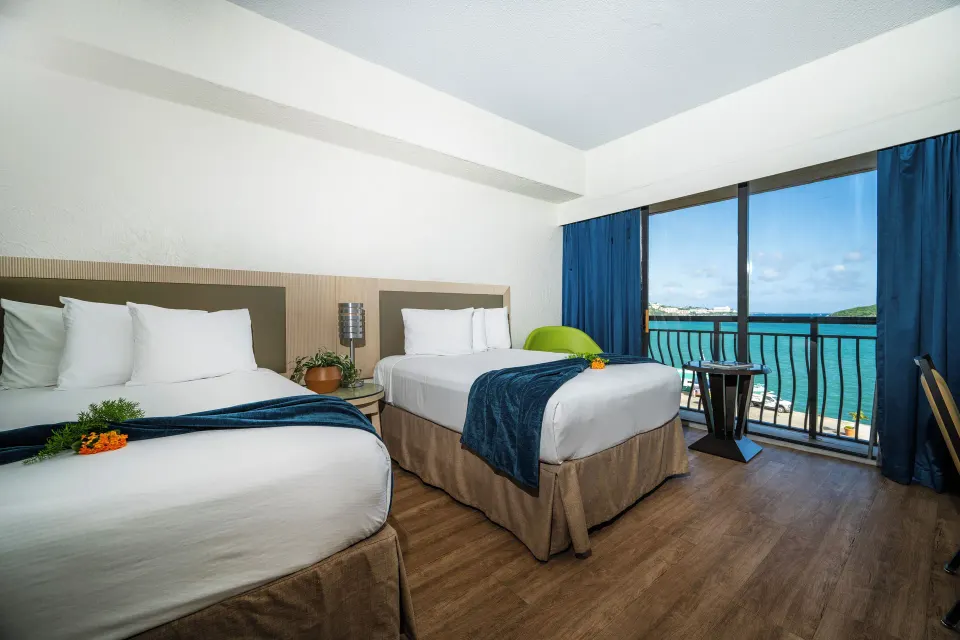 Superior Room Ocean View two beds beside balcony at Windward Passage Hotel.