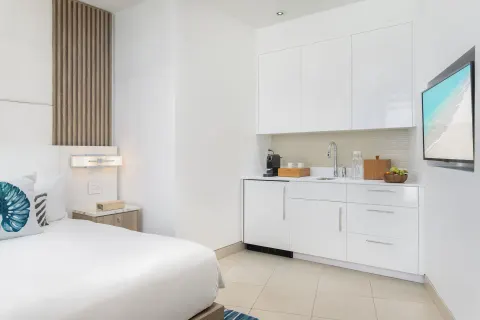 Guest room kitchenette and king bed detail at Wymara Resort and Villas.