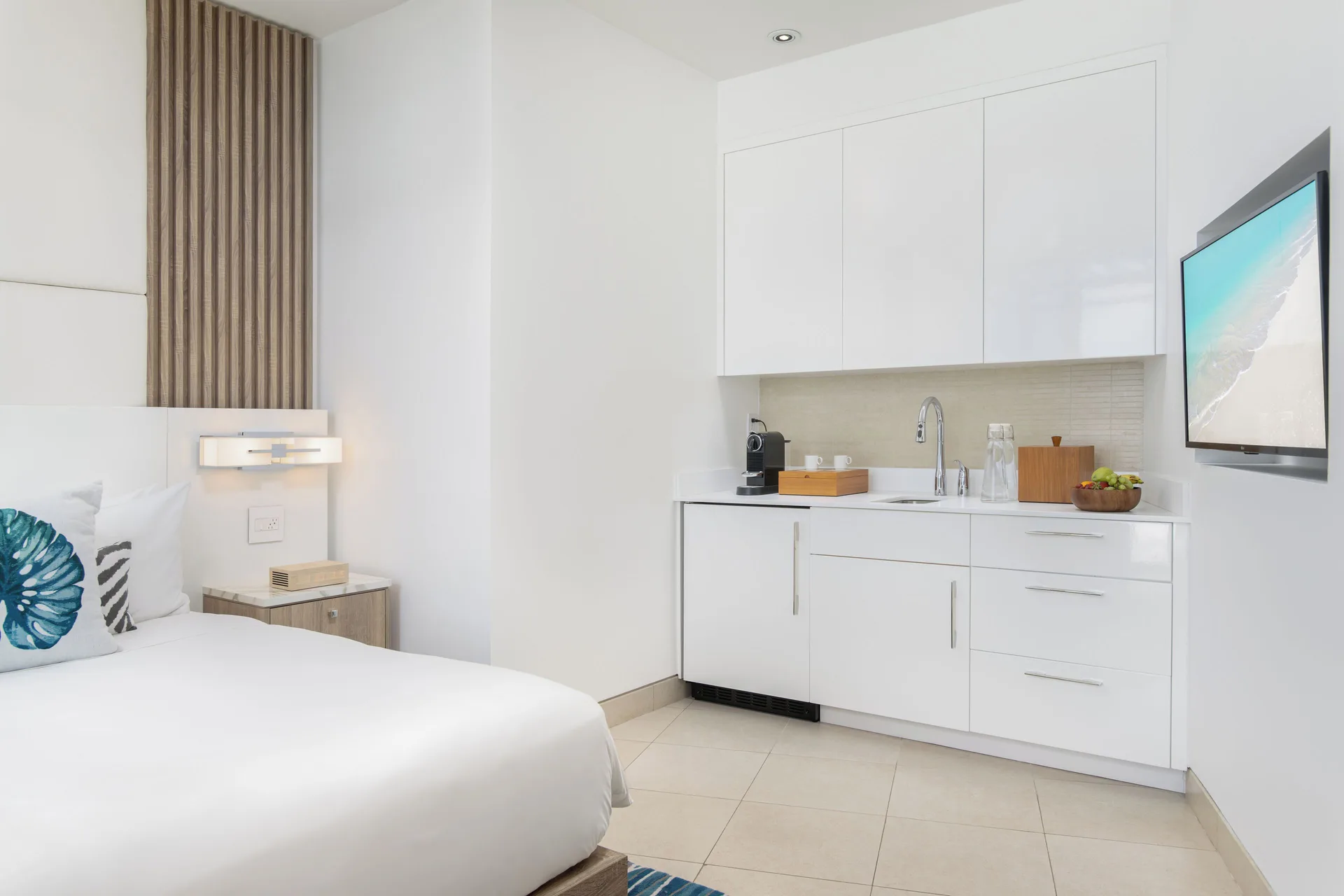 Guest room kitchenette and king bed detail at Wymara Resort and Villas.