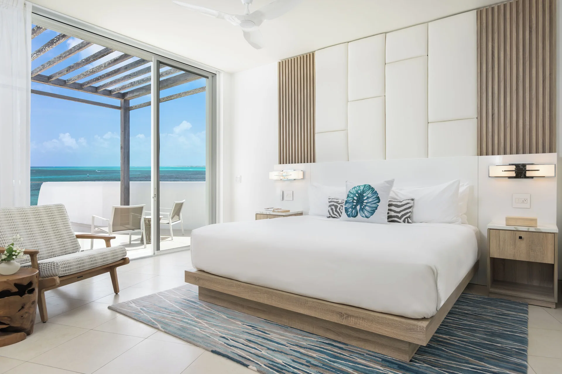 King bedroom with balcony and ocean view at Wymara Resort and Villas.