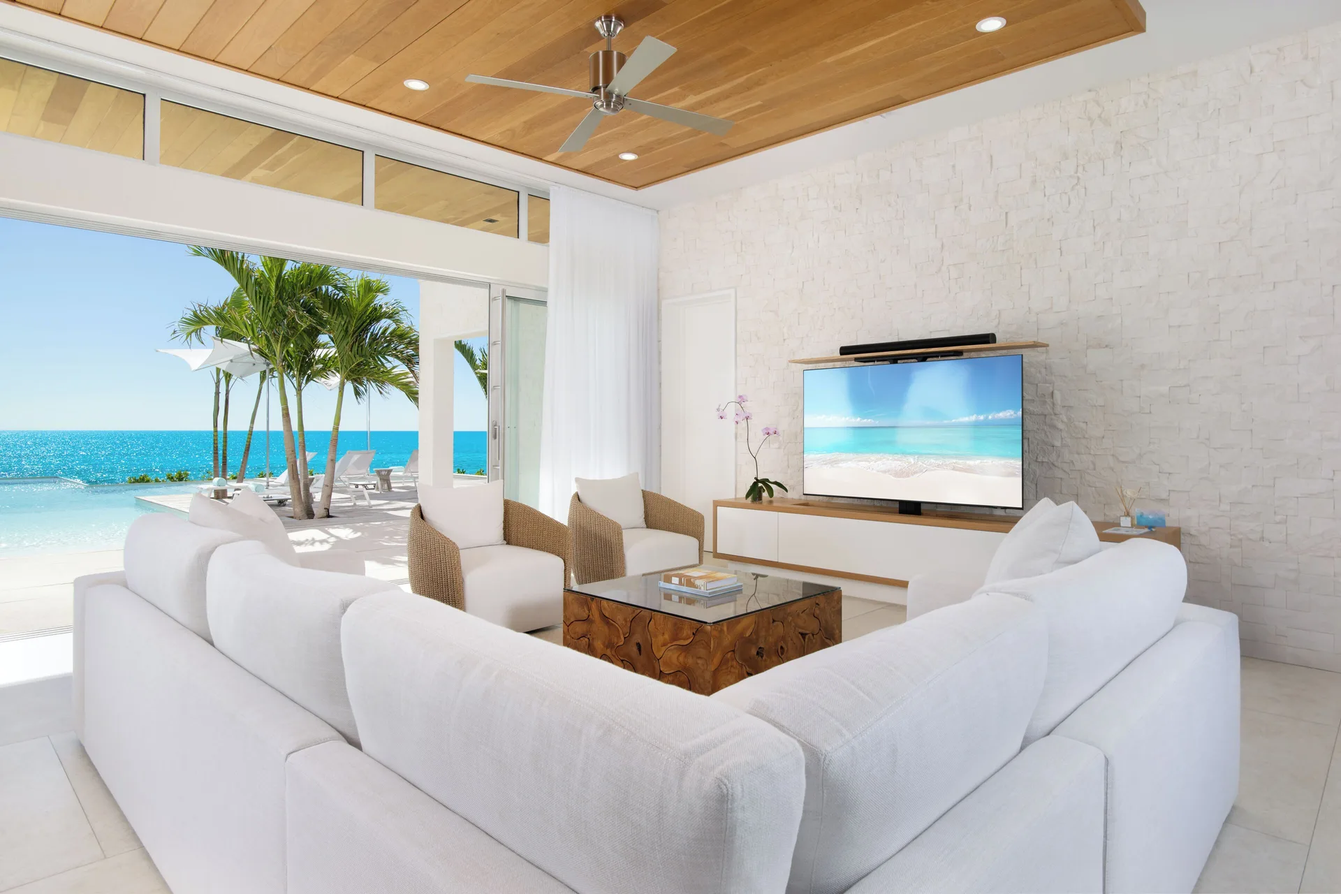 White sofa seating in an oceanfront villa living room at Wymara Resort and Villas.