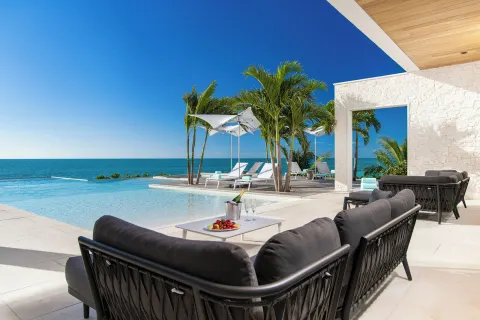Poolside terrace seating with ocean view at Wymara Resort and Villas.